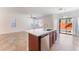 Open-concept kitchen featuring island seating, stainless steel appliances, and a view of the backyard at 4740 Killington St, Las Vegas, NV 89129
