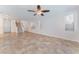 Spacious living area with tile flooring, staircase, and ample natural light at 4740 Killington St, Las Vegas, NV 89129