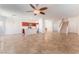 Open concept living room with tile flooring, ceiling fan, and kitchen view at 4740 Killington St, Las Vegas, NV 89129