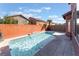Sparkling in-ground pool with ample patio space in a fenced backyard at 4740 Killington St, Las Vegas, NV 89129