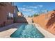 A private pool with stone coping sits between brick walls under a sunny sky at 4740 Killington St, Las Vegas, NV 89129