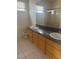 Bathroom featuring a granite countertop, dual sinks, tiled floor and shower at 5214 Monterey Park Cir, Las Vegas, NV 89146