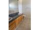 Bathroom showcasing granite countertop, dual sinks, tiled floor and a mirror at 5214 Monterey Park Cir, Las Vegas, NV 89146