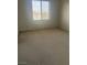 Bedroom featuring neutral carpet, white walls and natural light at 5214 Monterey Park Cir, Las Vegas, NV 89146
