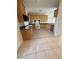 A functional kitchen with granite countertops, wooden cabinets, and tile flooring at 5214 Monterey Park Cir, Las Vegas, NV 89146