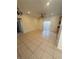 Spacious, tiled living area with ceiling fan, light, and a sliding door to the backyard at 5214 Monterey Park Cir, Las Vegas, NV 89146