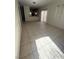Bright living room featuring durable tile flooring, and sliding door access to the backyard at 5214 Monterey Park Cir, Las Vegas, NV 89146