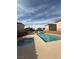Community pool with hot tub, surrounded by houses and clear sky at 5214 Monterey Park Cir, Las Vegas, NV 89146