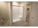 Modern bathroom features a glass shower, neutral tile, and access to a walk-in closet at 5269 Acadia Leaf St, Las Vegas, NV 89166