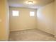 Bright bedroom with plush carpet, neutral walls, and natural light from two windows at 5269 Acadia Leaf St, Las Vegas, NV 89166