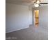 Large carpeted bedroom with ceiling fan and view into the adjoining bathroom and vanity at 5269 Acadia Leaf St, Las Vegas, NV 89166