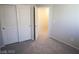 The carpeted bedroom has a sliding closet, and a wall painted with neutral color at 5269 Acadia Leaf St, Las Vegas, NV 89166