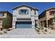 Charming two-story home featuring a blue garage door and beautiful neutral colored exterior at 5269 Acadia Leaf St, Las Vegas, NV 89166