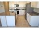 Bright kitchen boasts granite countertops, stainless steel appliances, and modern white cabinets at 5269 Acadia Leaf St, Las Vegas, NV 89166