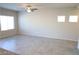 Spacious living area showcasing neutral walls, tiled floors, and a ceiling fan with light at 5269 Acadia Leaf St, Las Vegas, NV 89166