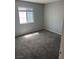 Bright bedroom featuring a large window and plush carpeting at 579 Roxella Ln # D, Las Vegas, NV 89110