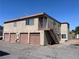 Multi-unit building with garages and exterior staircases offering easy access to upper-level apartments at 579 Roxella Ln # D, Las Vegas, NV 89110