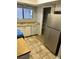 Functional kitchen with standard appliances, tiled floor, and a convenient pantry at 579 Roxella Ln # D, Las Vegas, NV 89110