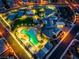 Aerial view of the pool and clubhouse at Regency at Summerlin, with palm trees and manicured lawns at 6801 Steel Mist St, Las Vegas, NV 89148