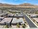 A gorgeous aerial view of the home nestled in a desert community surrounded by desert landscaping at 6801 Steel Mist St, Las Vegas, NV 89148
