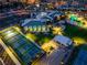 Aerial night shot of community clubhouse with tennis courts, bocce ball, and pool at 6801 Steel Mist St, Las Vegas, NV 89148