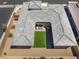 Captivating aerial perspective showcasing the home's unique architecture and inviting outdoor living space with turf at 6801 Steel Mist St, Las Vegas, NV 89148