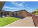 Well-maintained backyard offers a blend of artificial turf, desert landscaping, and a patio area for outdoor enjoyment at 6801 Steel Mist St, Las Vegas, NV 89148