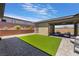 Well-maintained backyard features artificial turf, patio area, outdoor seating, and desert landscaping for low maintenance living at 6801 Steel Mist St, Las Vegas, NV 89148