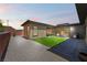 Inviting backyard features artificial turf, patio furniture, and a built-in grill, ideal for outdoor entertaining at 6801 Steel Mist St, Las Vegas, NV 89148
