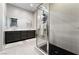 Modern bathroom with dual sink vanity, marble counters, large walk-in shower featuring sleek gray tile at 6801 Steel Mist St, Las Vegas, NV 89148