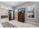 Bright bedroom features carpet, TV, large mirror, window shutters and ensuite bathroom at 6801 Steel Mist St, Las Vegas, NV 89148