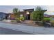 Attractive modern home featuring desert landscaping, a two-car garage, and a welcoming front entrance at 6801 Steel Mist St, Las Vegas, NV 89148