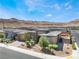 Charming single-story house with desert landscaping, a paved driveway, and a mountain view at 6801 Steel Mist St, Las Vegas, NV 89148