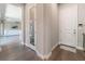 Bright hallway with hardwood floors leads to a spacious living room, offering a welcoming transition in the home at 6801 Steel Mist St, Las Vegas, NV 89148