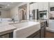 Modern kitchen with a stainless refrigerator and a white farmhouse sink at 6801 Steel Mist St, Las Vegas, NV 89148