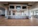 A gourmet kitchen with stainless steel appliances and three TVs above a large island at 6801 Steel Mist St, Las Vegas, NV 89148