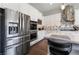 Modern kitchen features stainless appliances, custom tile backsplash, and white cabinets at 6801 Steel Mist St, Las Vegas, NV 89148