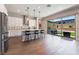 Charming kitchen features stainless steel appliances, white cabinetry, hardwood floors, and backyard access at 6801 Steel Mist St, Las Vegas, NV 89148