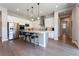 Bright kitchen features stainless steel appliances, white cabinets, and hardwood floors at 6801 Steel Mist St, Las Vegas, NV 89148