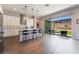 Charming kitchen features stainless steel appliances, white cabinetry, hardwood floors, and backyard access at 6801 Steel Mist St, Las Vegas, NV 89148