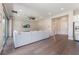 Bright living room with hardwood floors, recessed lighting, and a large sectional couch near sliding glass doors at 6801 Steel Mist St, Las Vegas, NV 89148