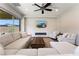 Spacious living room features a sectional, two arm chairs, modern fireplace, and sliding glass doors to patio at 6801 Steel Mist St, Las Vegas, NV 89148