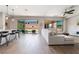 Bright living room features hardwood floors, modern ceiling fan and glass doors to backyard at 6801 Steel Mist St, Las Vegas, NV 89148