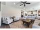 Bright living room featuring hardwood floors, recessed lights, a ceiling fan, and open floorplan to kitchen at 6801 Steel Mist St, Las Vegas, NV 89148