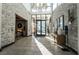 Grand lobby area with stone walls, pendant lighting, and tiled floors at 6801 Steel Mist St, Las Vegas, NV 89148