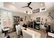 Home office with vaulted ceilings, plantation shutters, built-in shelves, and comfortable seating for work or relaxation at 6801 Steel Mist St, Las Vegas, NV 89148