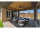 Covered patio features brick flooring, ceiling fan, and outdoor seating area, perfect for outdoor gatherings at 6801 Steel Mist St, Las Vegas, NV 89148