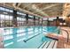 Indoor pool area with natural light, lounge chairs, and clear blue water, perfect for swimming laps or relaxing at 6801 Steel Mist St, Las Vegas, NV 89148