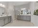 Bathroom with double vanity, shower, and neutral wall paint at 8729 Marcana St, Las Vegas, NV 89166