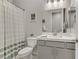 Well-lit bathroom featuring a modern vanity, framed mirror and shower with curtain at 8729 Marcana St, Las Vegas, NV 89166